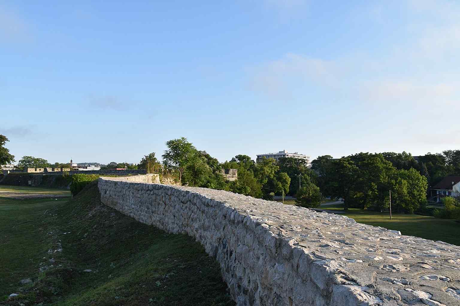 This image captures the ancient ruins and open areas within Kastel, illustrating its foundation on previous fortifications dating back to Roman and even pre-Roman periods, as evidenced by archaeological discoveries.