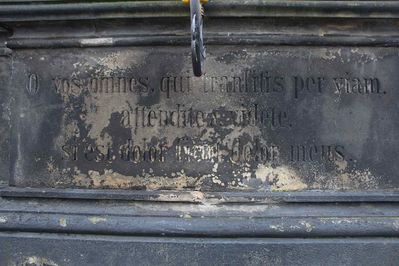 This wider view emphasizes the Pietà's integration into the historic row of statues along the Charles Bridge, a landmark frequently exposed to the elements and millions of tourists.