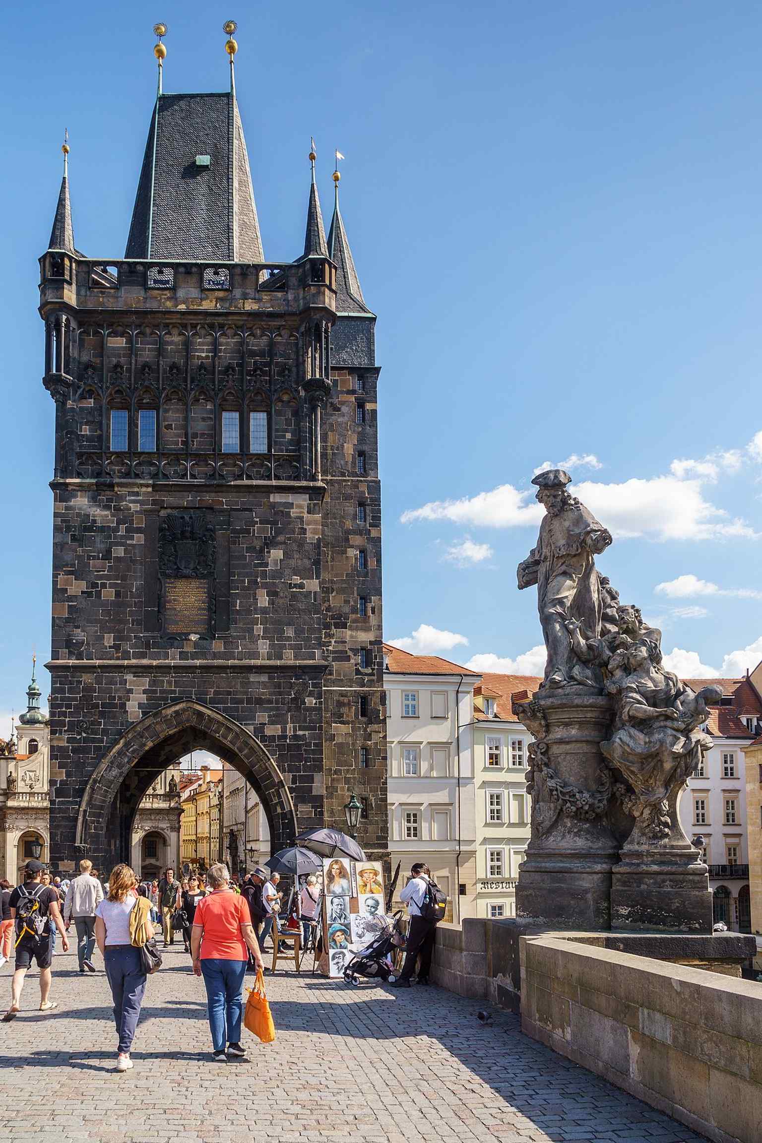 The Statue of Saint Ivo, seen here with the Old Town Bridge Tower, marks the Old Town end of Charles Bridge where it was originally commissioned.