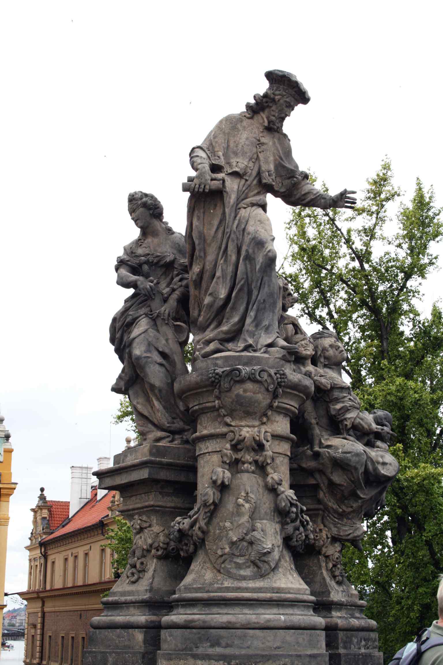 Saint Ivo is depicted in a contemporary judge's robe and cap, reflecting his role as a 13th-century Breton priest and judge of the ecclesiastical court.