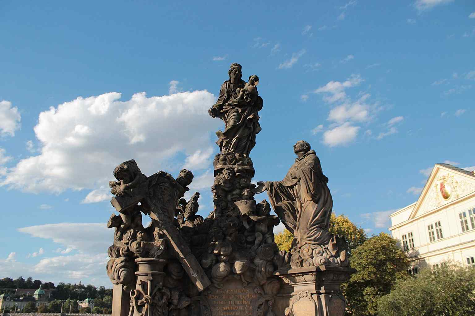 The replica of the statues bathed in sunset light, highlighting the "lighter color" mentioned for newer copies compared to the weathered originals.