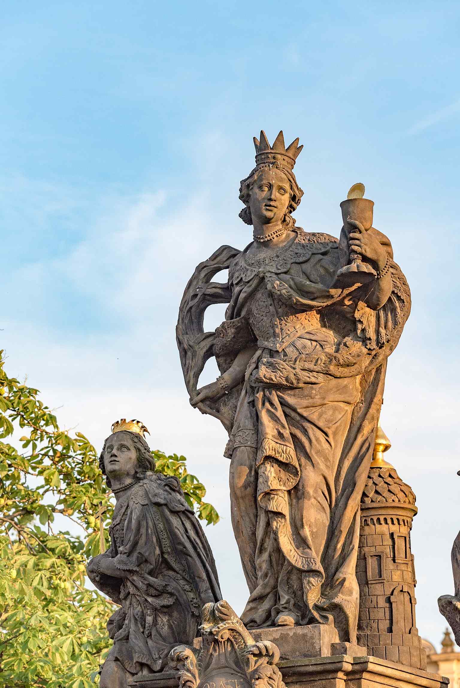 Saint Margaret of Antioch triumphantly resting her foot on a dragon, clutching a gilded cross, symbolizing her escape and faith that overcame the devil.