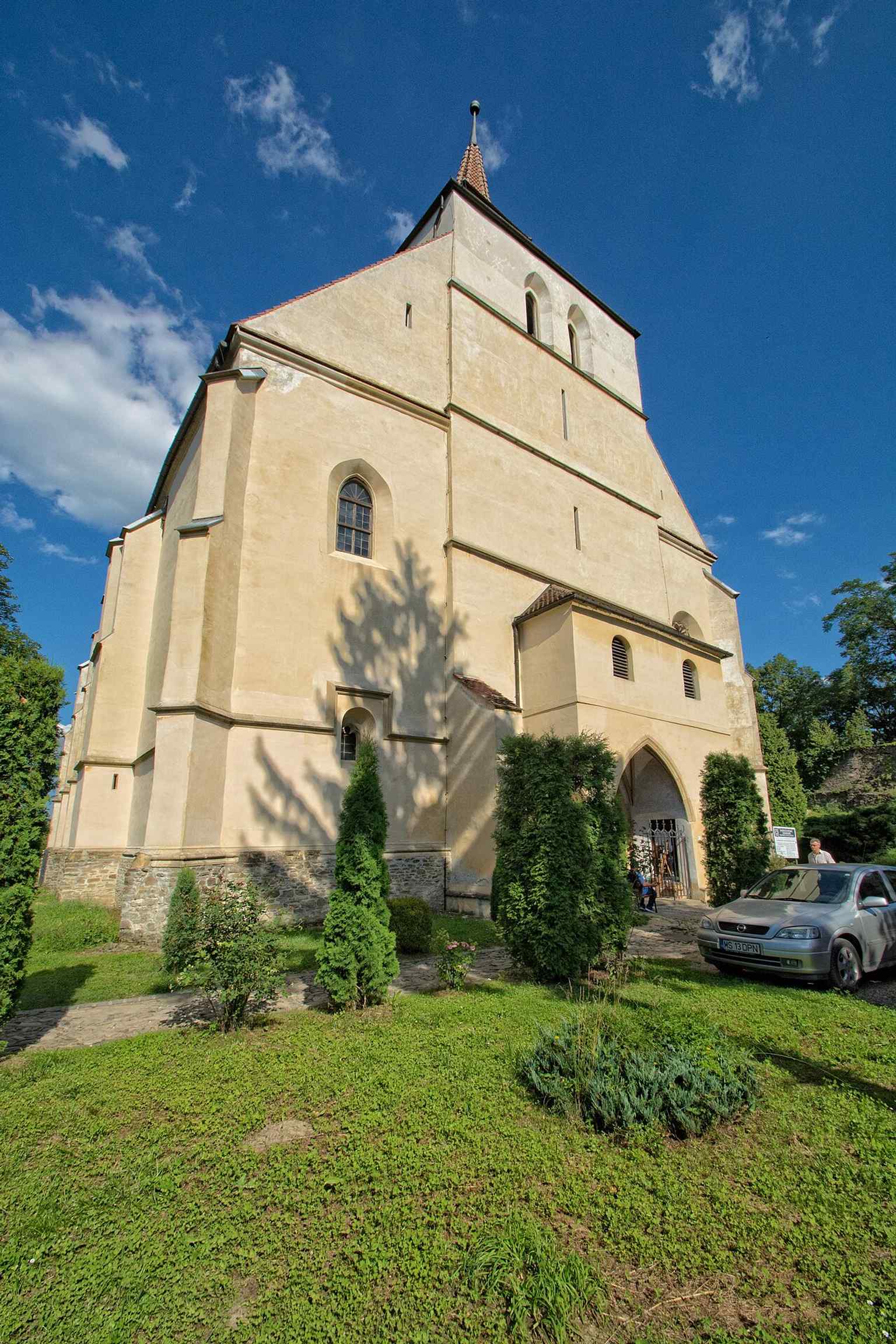A direct view of the church's exterior, characterized by its simplicity, which contrasts with Western European Gothic monuments, typical of fortified Saxon churches in Transylvania.