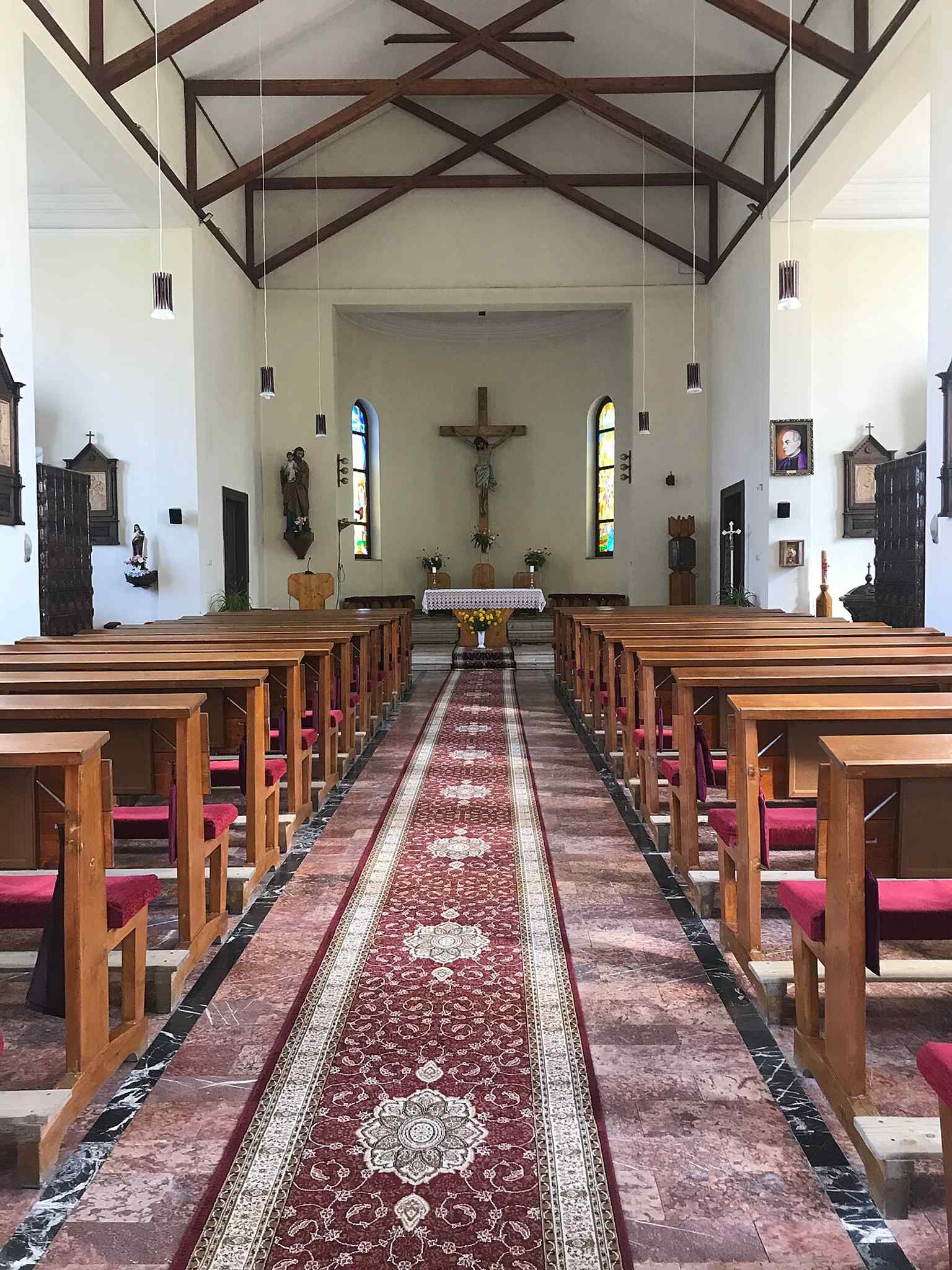 The interior reflects the reconstruction after the devastating 1983 fire, resulting in a more contemporary feel compared to its eclectic exterior, though some historical artifacts like altars and the baptismal font were miraculously preserved.