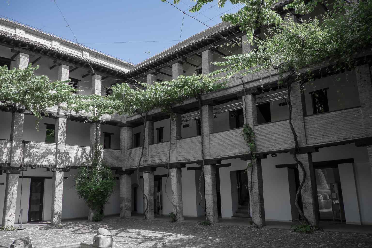 The central courtyard is surrounded by a three-story gallery, where visiting merchants would sleep on the upper floors after securing their goods below.