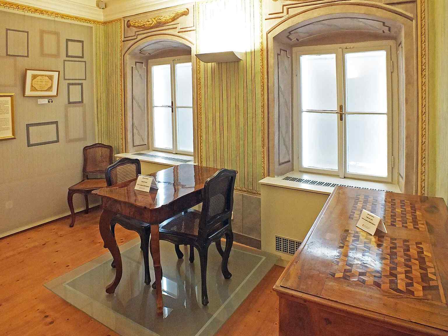 A furnished living room from the museum presentation, showing the restored domestic atmosphere based on Haydn-era wall paintings and furniture.