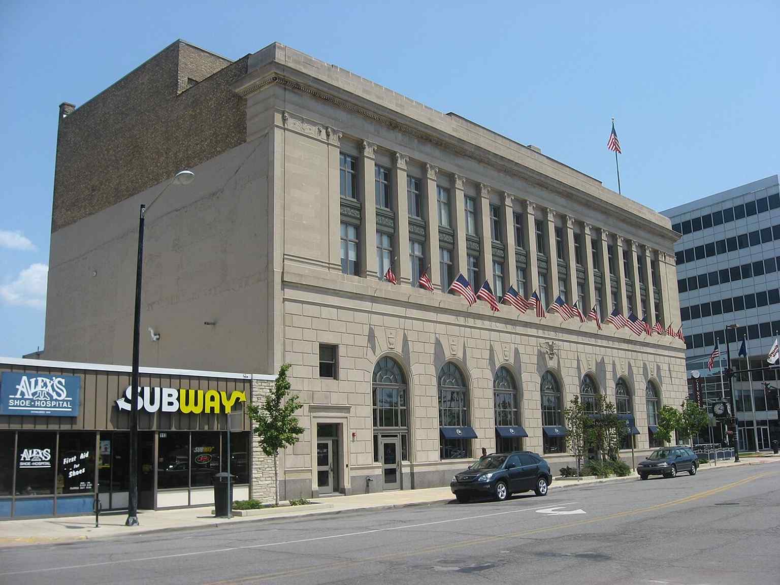 Front and west side of the 1924 All American Bank Building in South Bend, a four-story Classical Revival landmark built from Indiana limestone.
