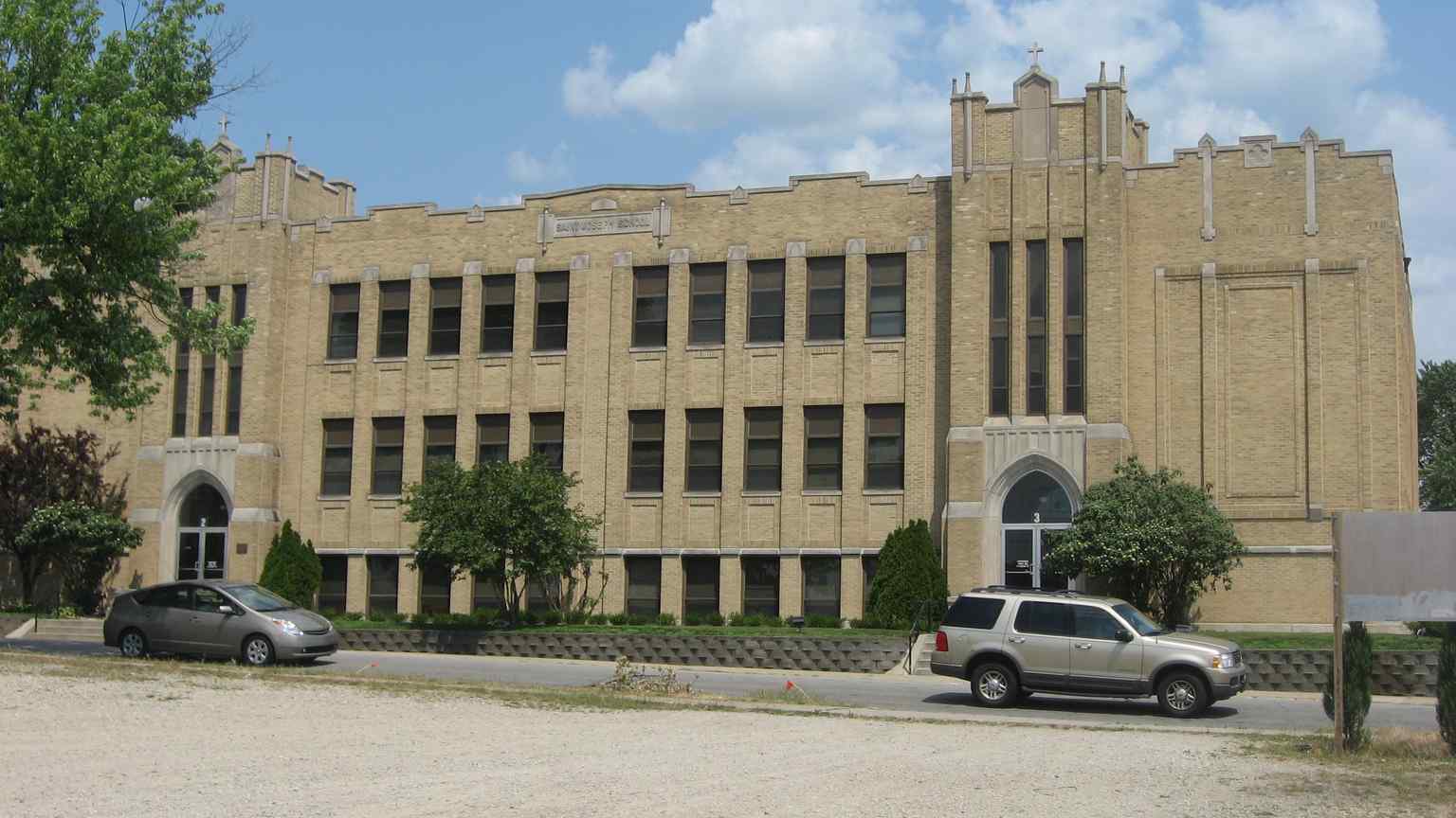 This is the Late Gothic Revival style tan brick building constructed in 1925, listed on the National Register of Historic Places in 1999.