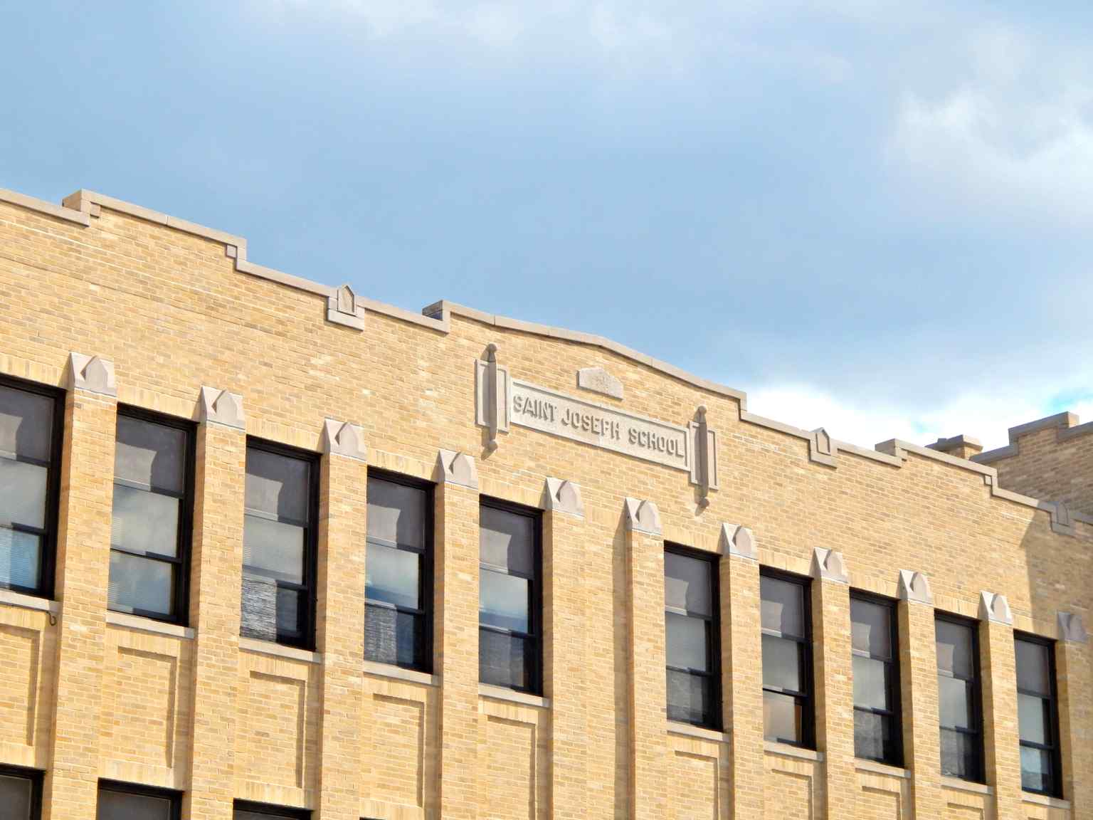 The school's name proudly displayed on its west wall, part of the 1925 structure built by alumnus Thomas L. Hickey.