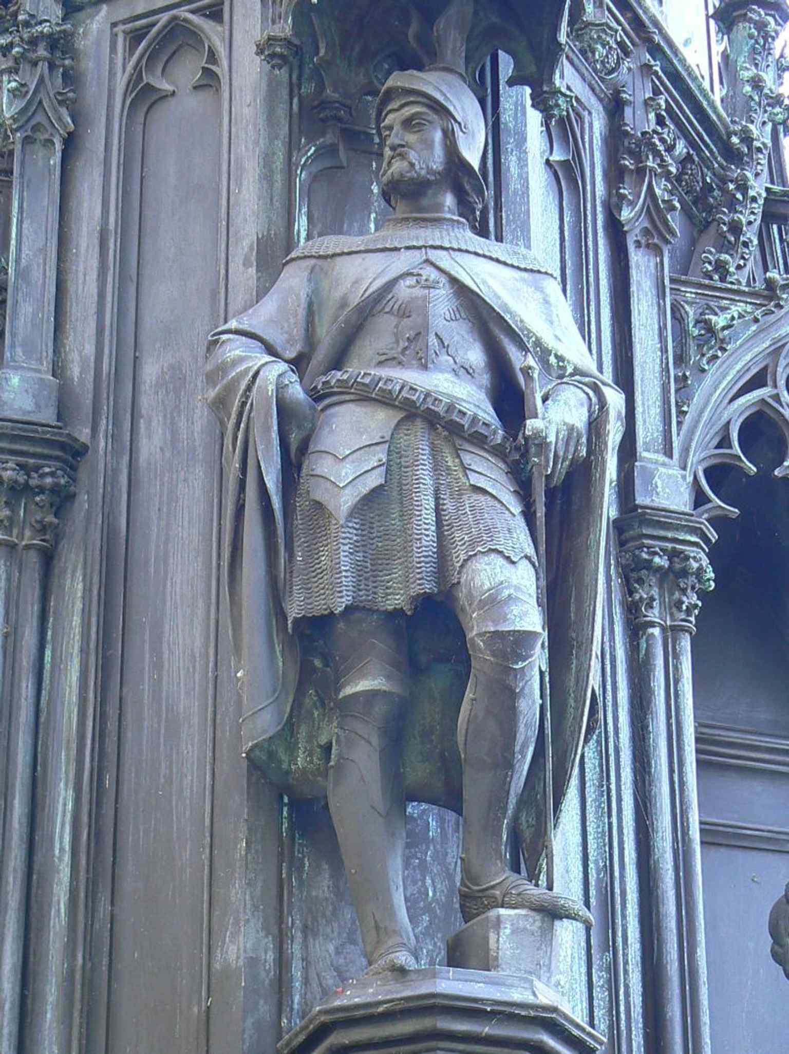One of the standing figures on the pedestal, possibly chronicler Beneš of Weitmühle or another of Emperor Charles IV's advisors.