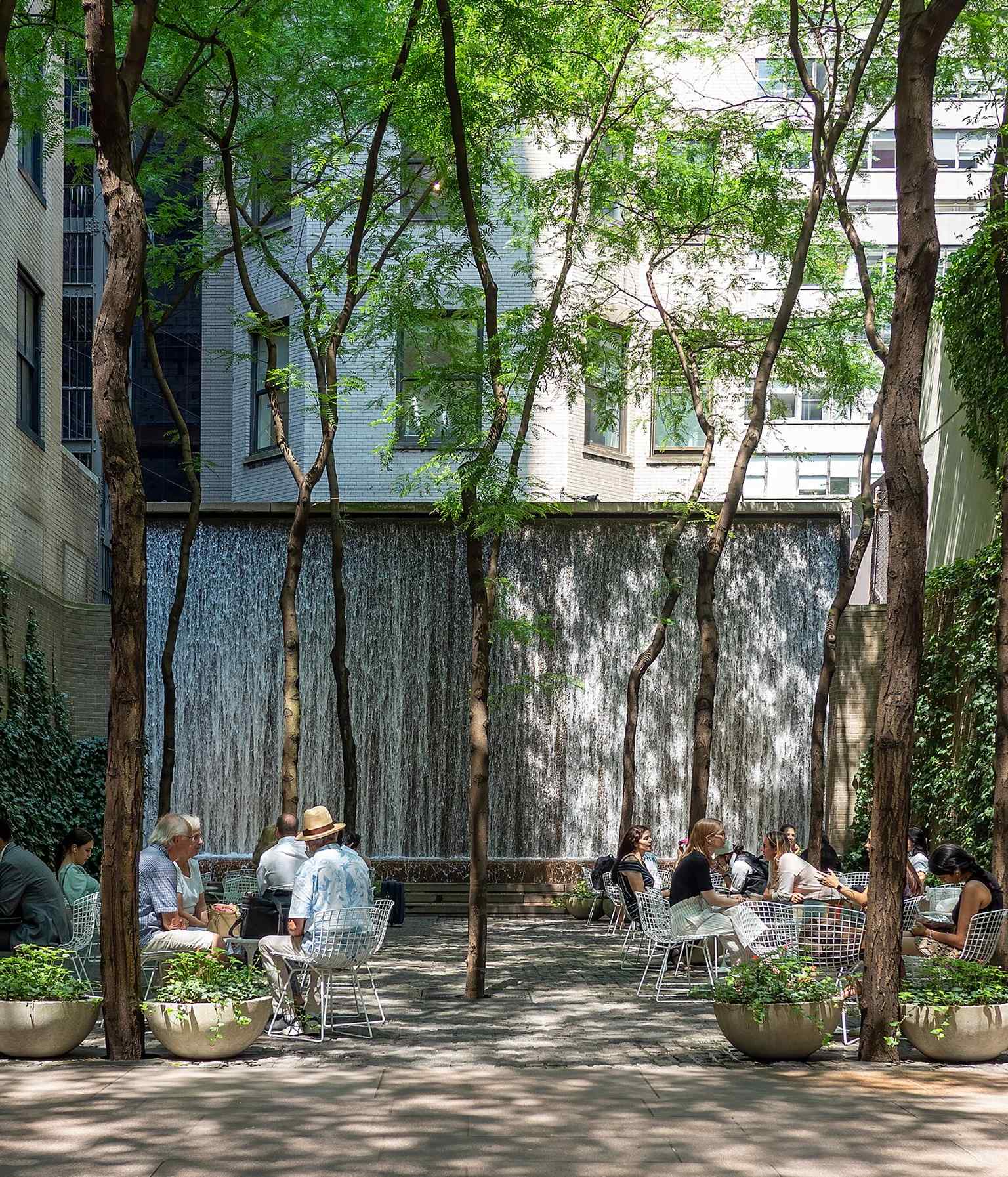 A broad view of the park’s lush interior, where trees and ivy make a rare green refuge in dense Midtown.
