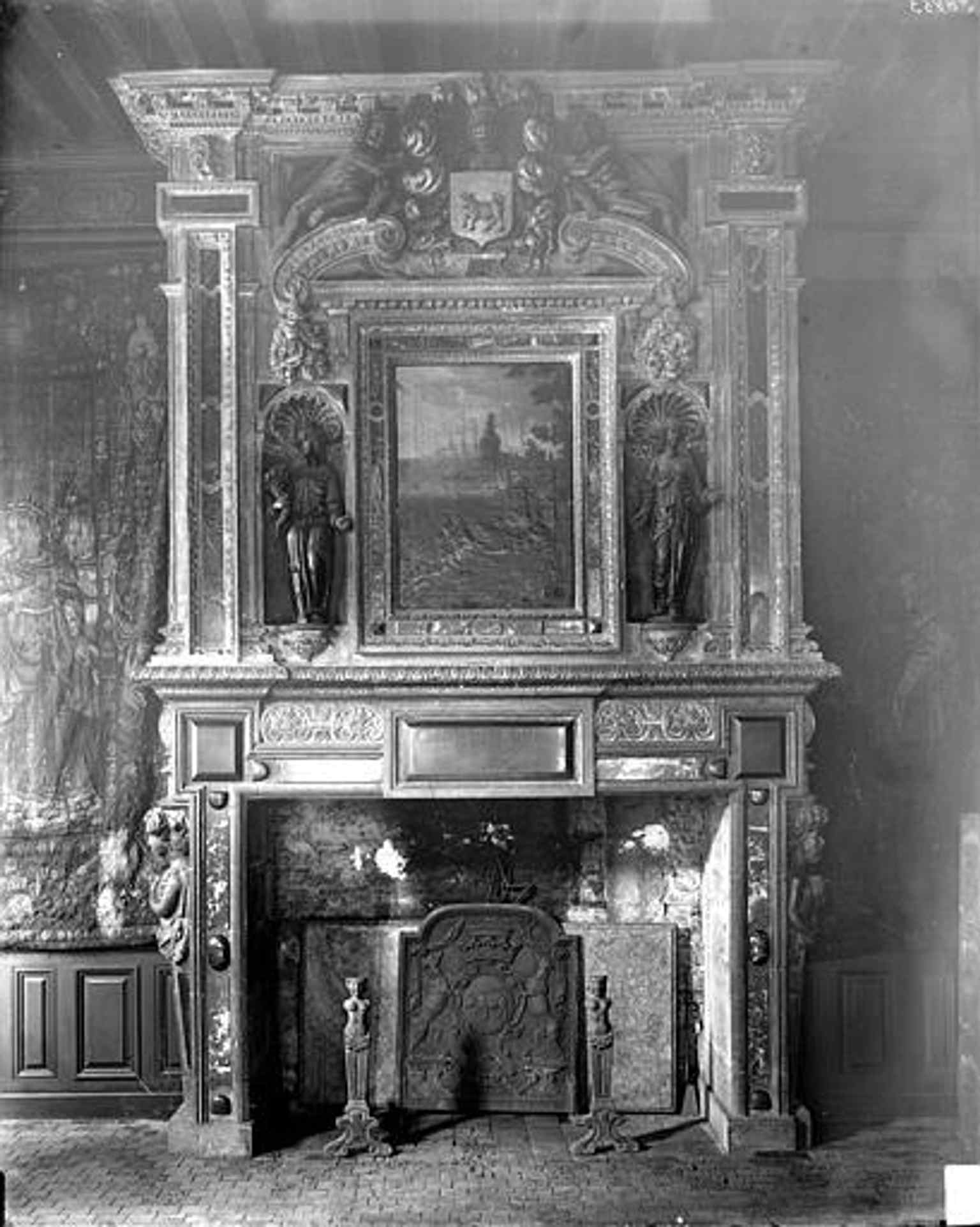 This 1919 historical image depicts the grand fireplace in the Guard Room, which features caryatids and a painting representing Hero and Leander, as mentioned in the family tradition.