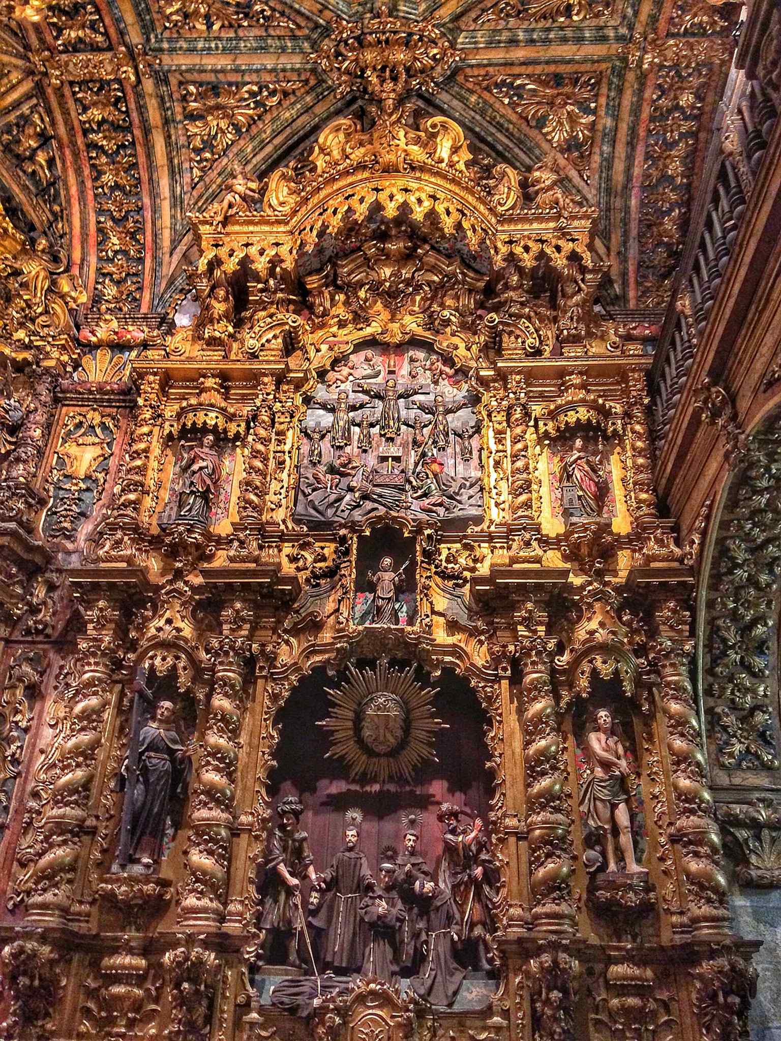 The retable of the Martyrs of Morocco, part of the major 18th-century decorative cycle that reshaped the church’s chapels.