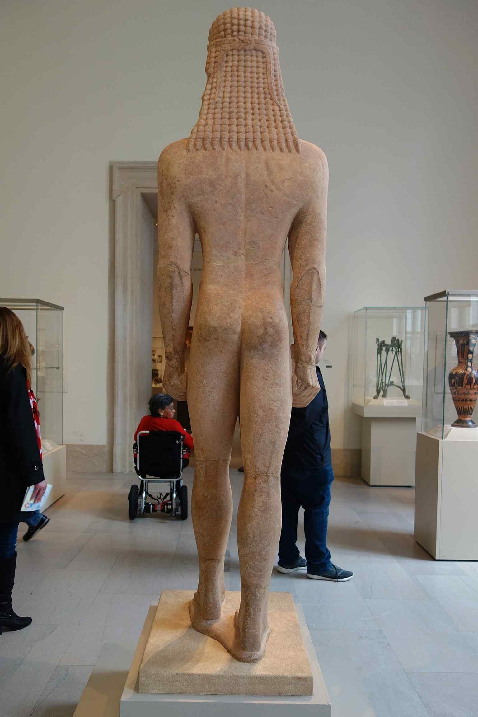 A modern high-resolution photograph of the kouros at The Met Fifth Avenue, where the c. 590–580 BCE sculpture is now displayed in gallery context.