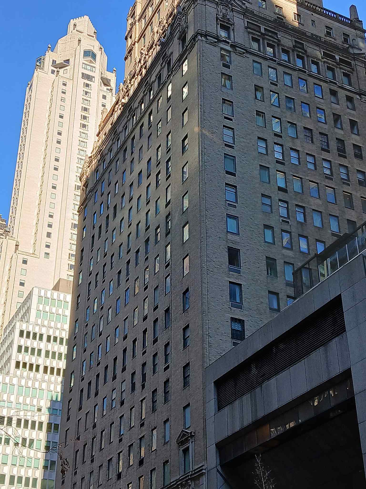 The Ritz Tower beside the Galleria, showing how the landmark’s 1920s luxury design now shares the avenue with later high-rise neighbors.
