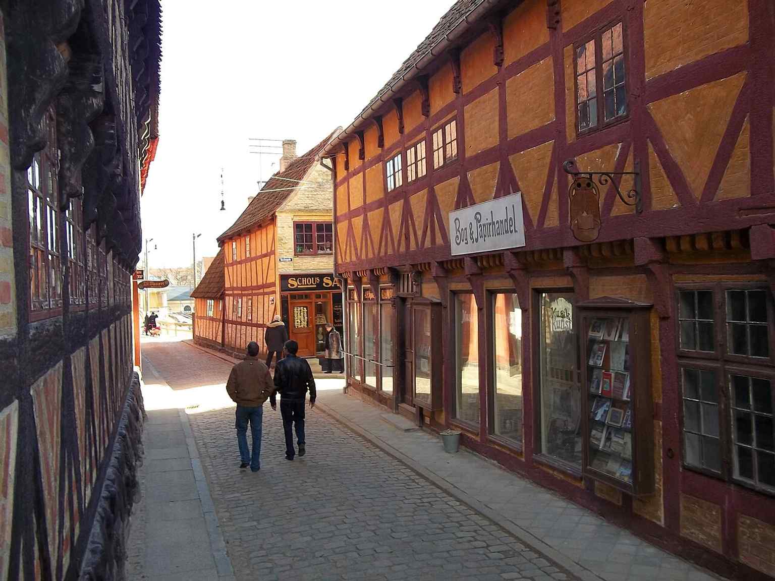 A street view inside the museum town, where historic houses and shopfronts recreate the life of a Danish market town across the last 300 years.