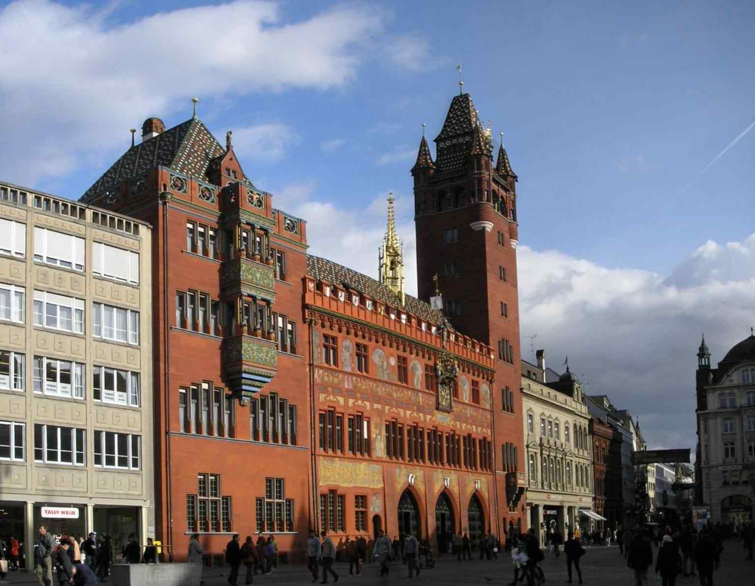 A classic view of Basel City Hall’s red façade and tower, the rebuilt landmark that became a political statement after Basel joined the Confederation in 1501.