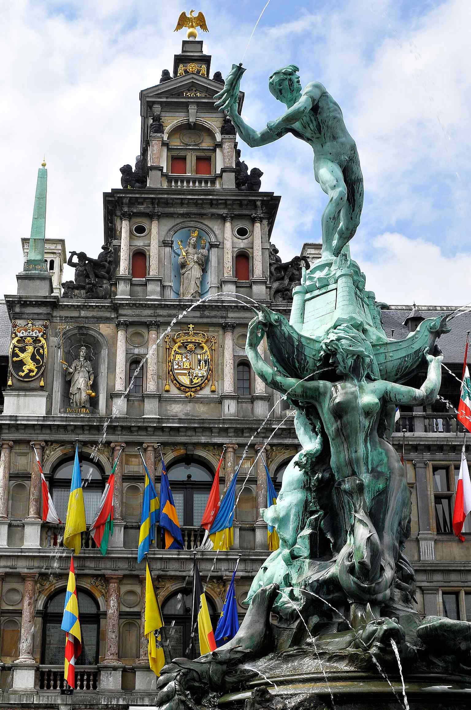 A wider corner view of the Town Hall and Brabo Fountain, useful for placing the monument in the heart of Antwerp’s main square.