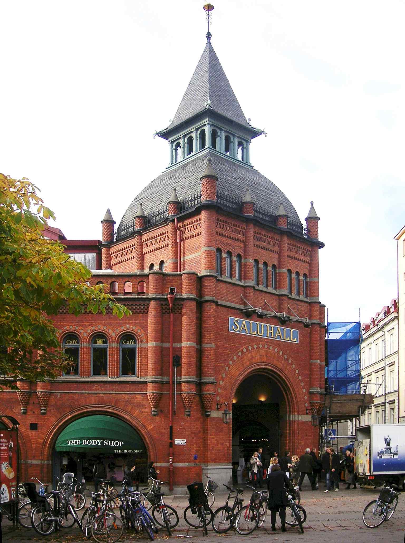 The market hall’s brick facade and corner tower show the 1888 building that became Östermalm’s grand food hall.