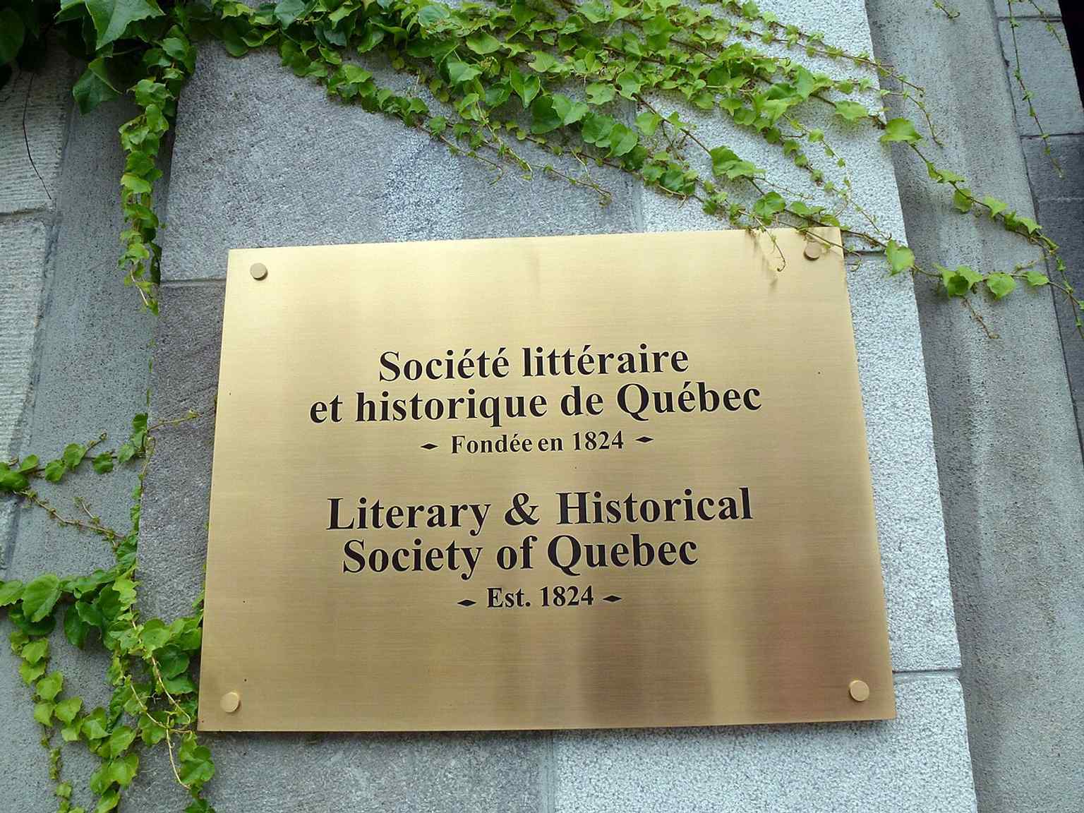 The Morrin Centre identification plaque, marking the site’s layered history as a prison, college, and literary society home.