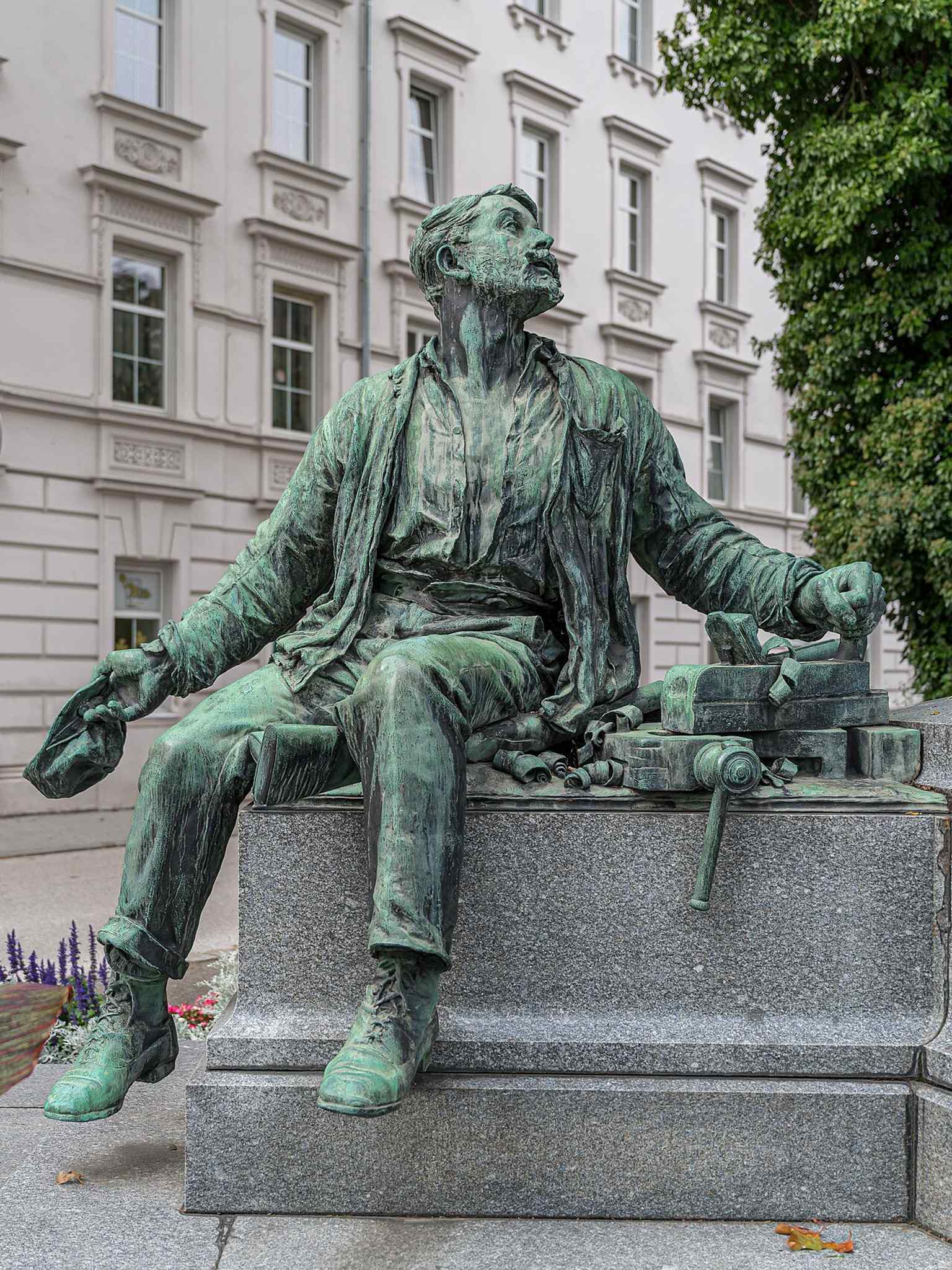 One of the worker figures below Werndl — the carpenter, part of Tilgner’s unusual monument where labor stands beside the industrialist.