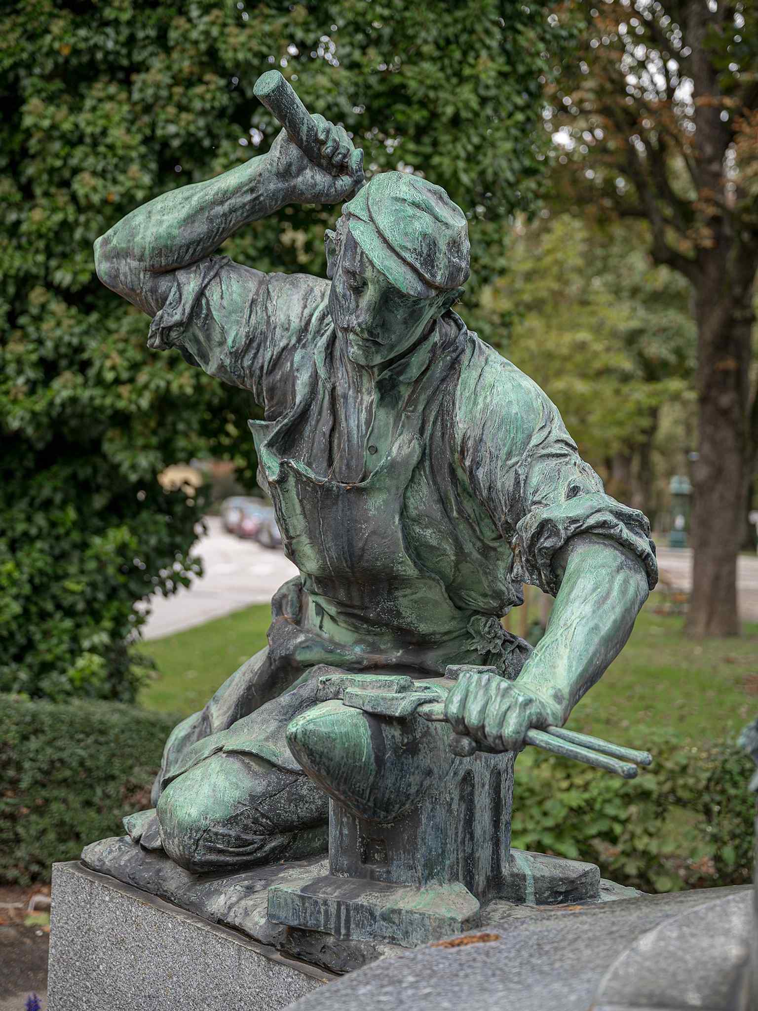 A blacksmith from the monument’s group of workers, reflecting the text’s theme that 'work honors' the monument.