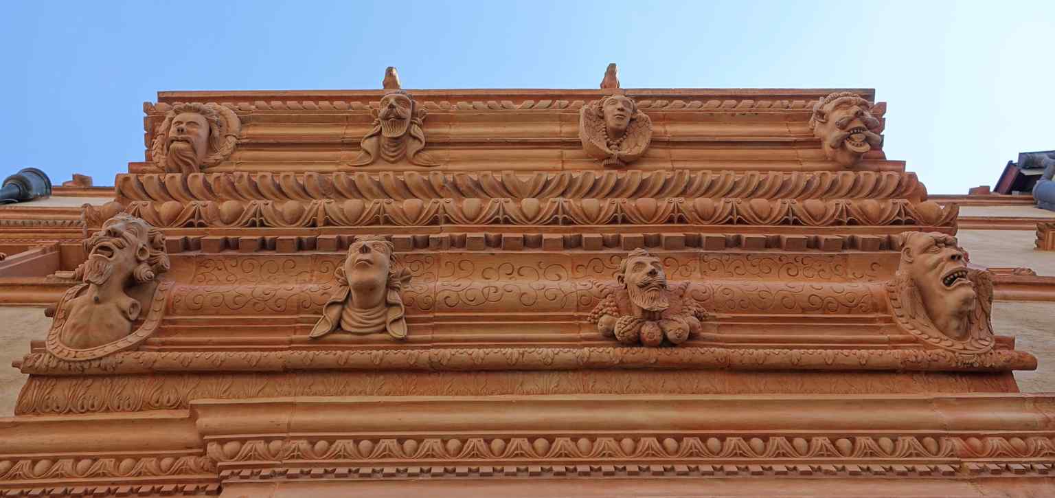 A close-up view from 2019 detailing some of the intricate and bizarre stone mascarons that give the house its iconic name.