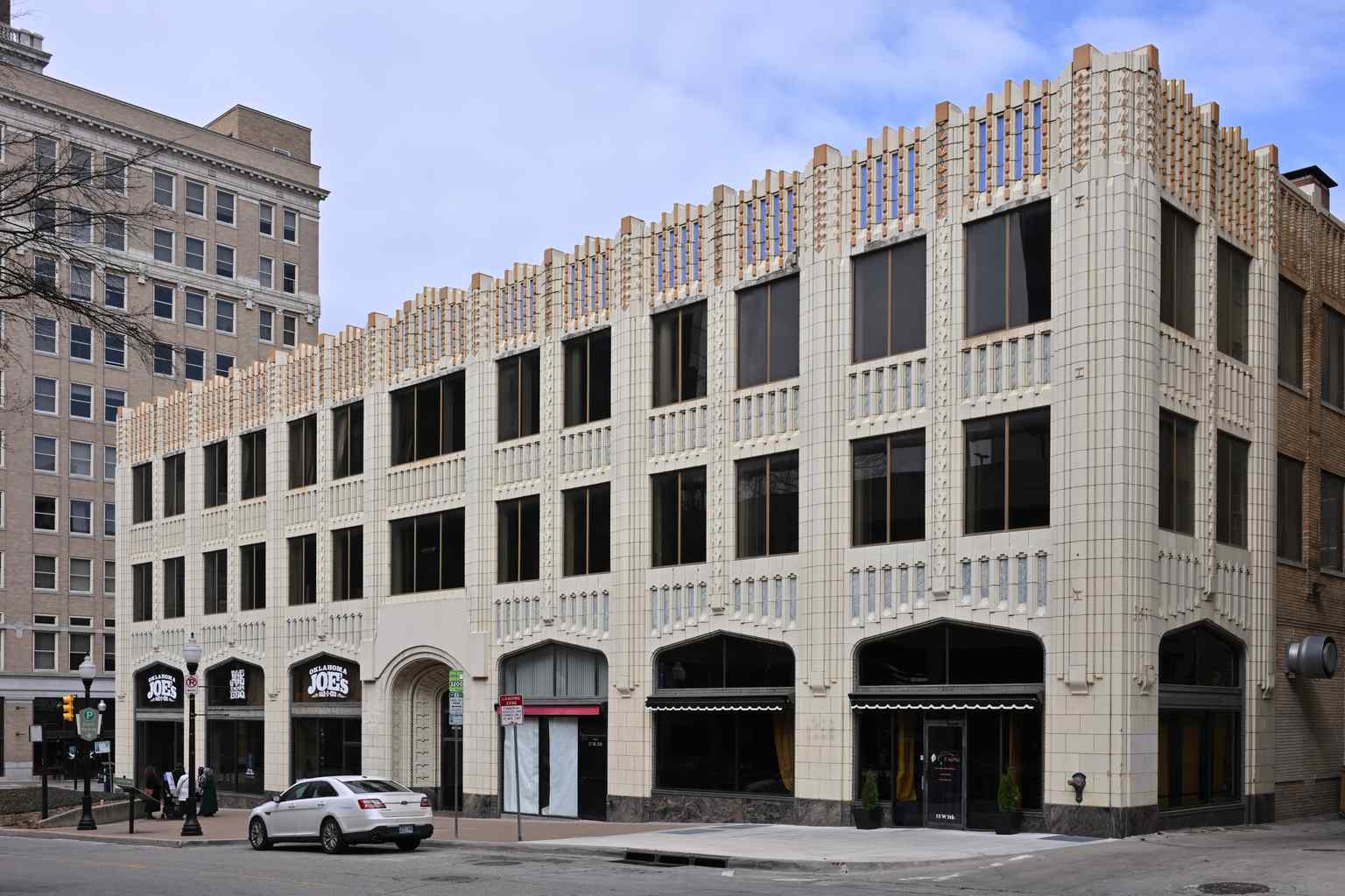 The Pythian Building, seen from South Boulder Avenue, showcases the Art Deco 'zig-zag' pattern on its vertical piers and was listed on the National Register of Historic Places in 1982.