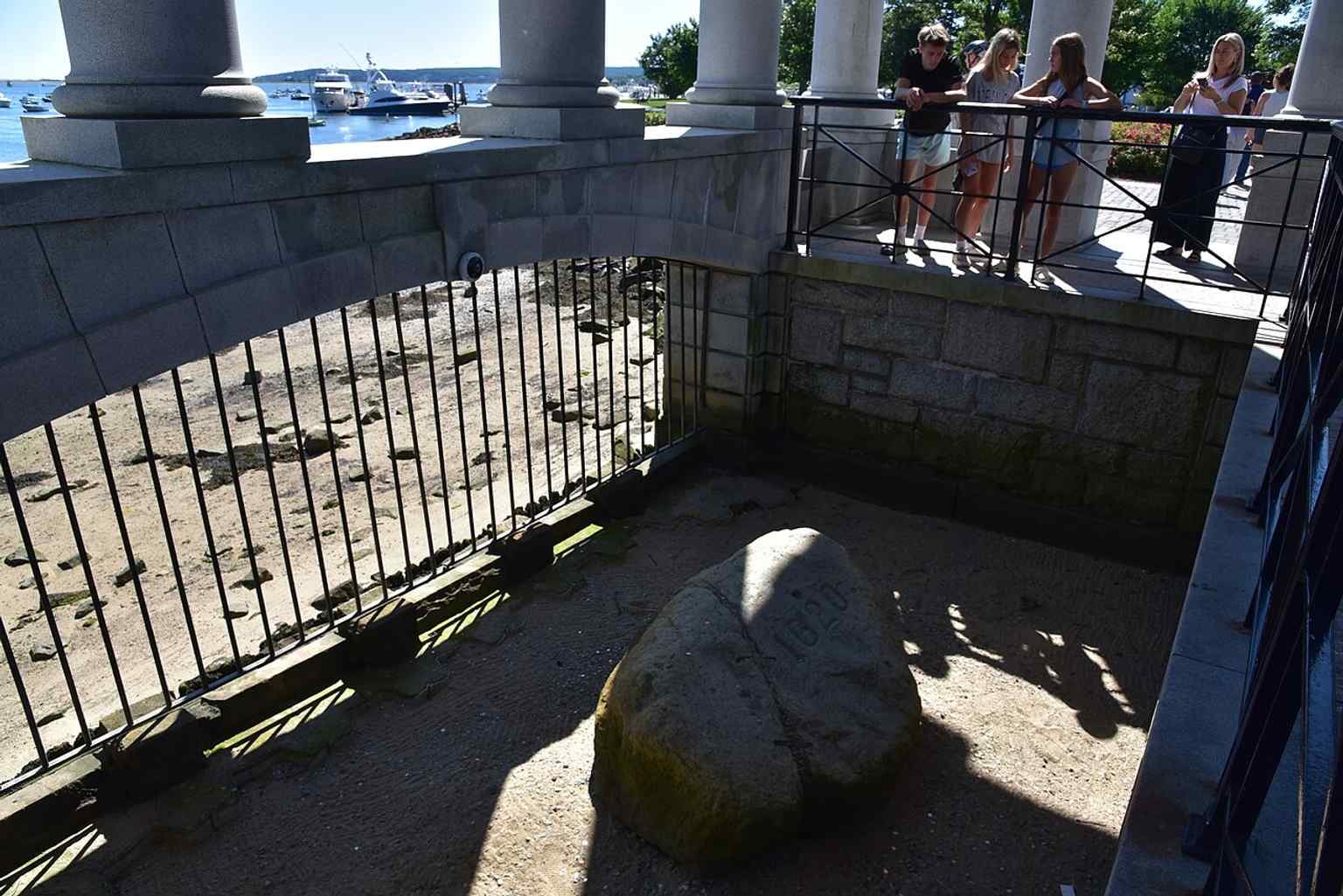 Today, visitors peer down at Plymouth Rock, which is now managed by the Department of Conservation and Recreation as part of Pilgrim Memorial State Park.
