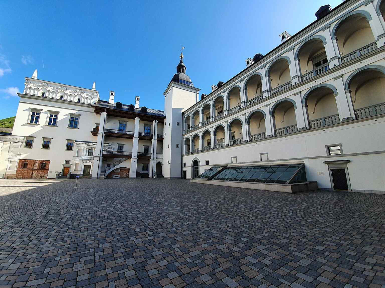 The Grand Courtyard framed by the palace wings and balconies — a strong image of the 2018 reconstruction in Renaissance style.