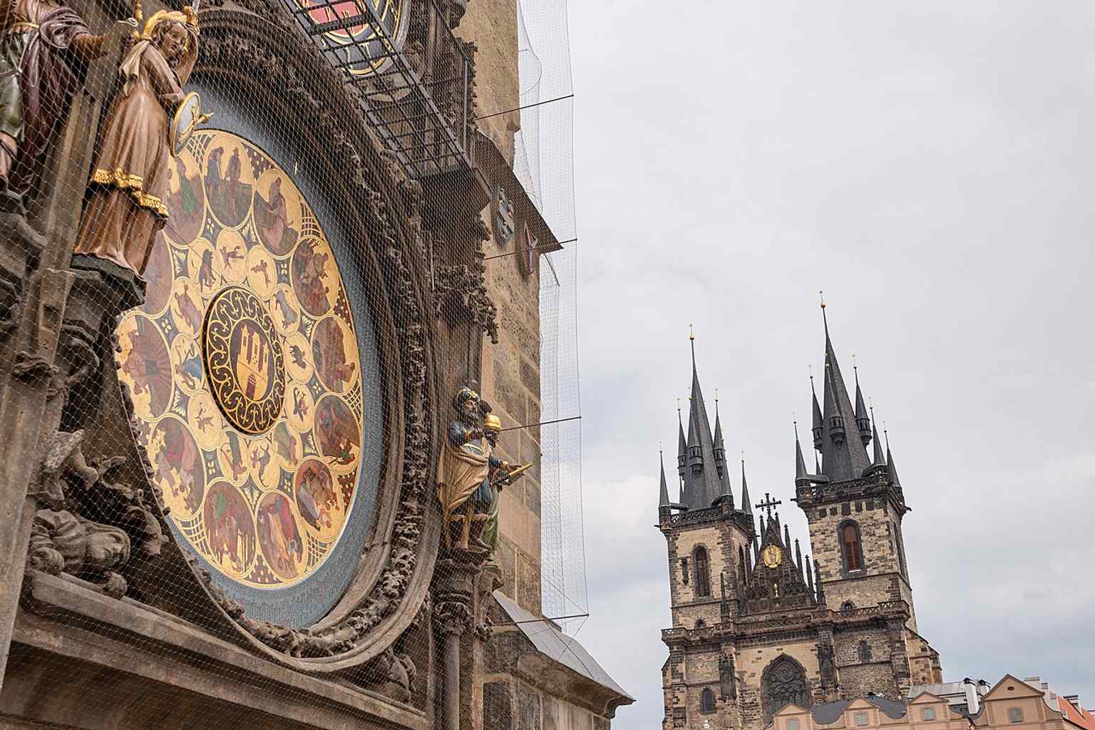 The Old Town Astronomical Clock stands proudly above the bustling Old Town Square, a central hub of Prague's history and public life.