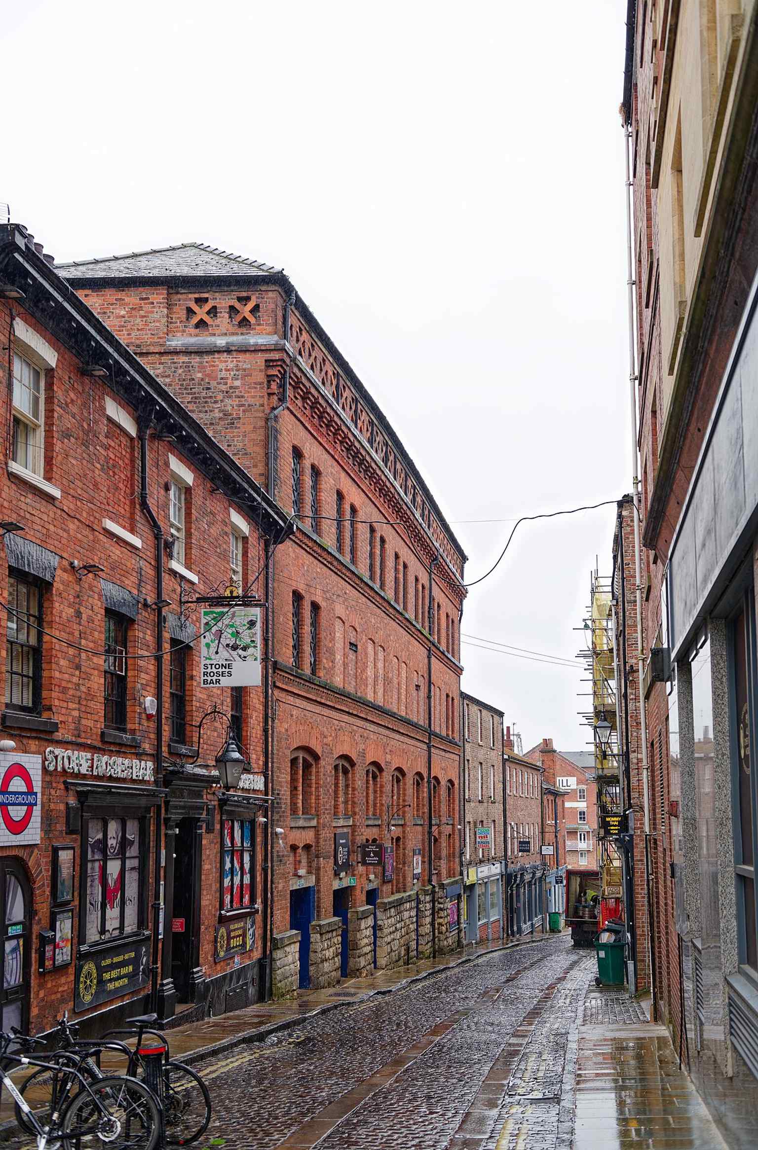 A tall street view of the Grand Opera House on Clifford Street, useful for showing the building’s red-brick theatre-and-corn-exchange hybrid form.