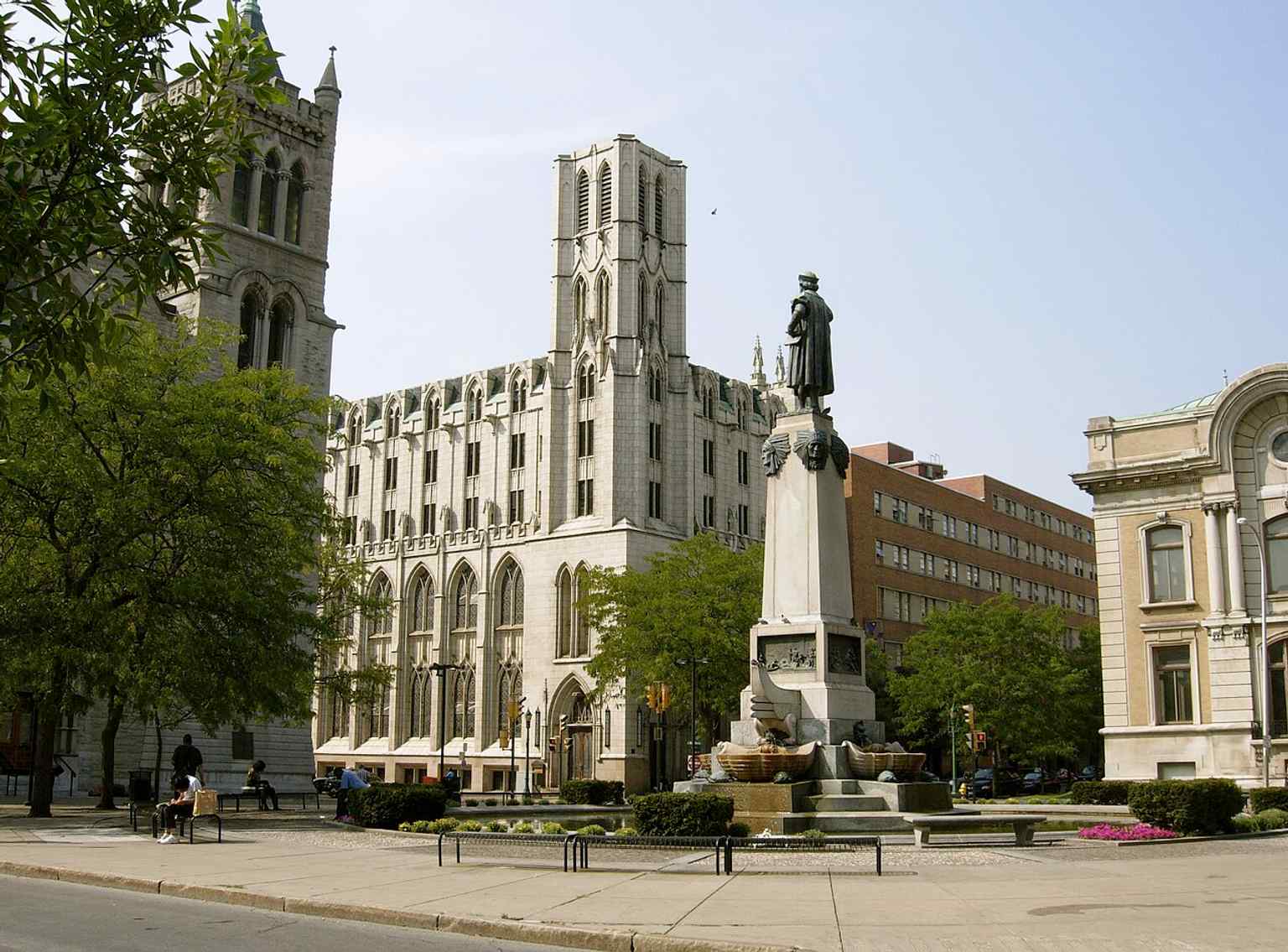 A broad view of Columbus Circle, where the fountain and monument anchor downtown Syracuse’s civic core.