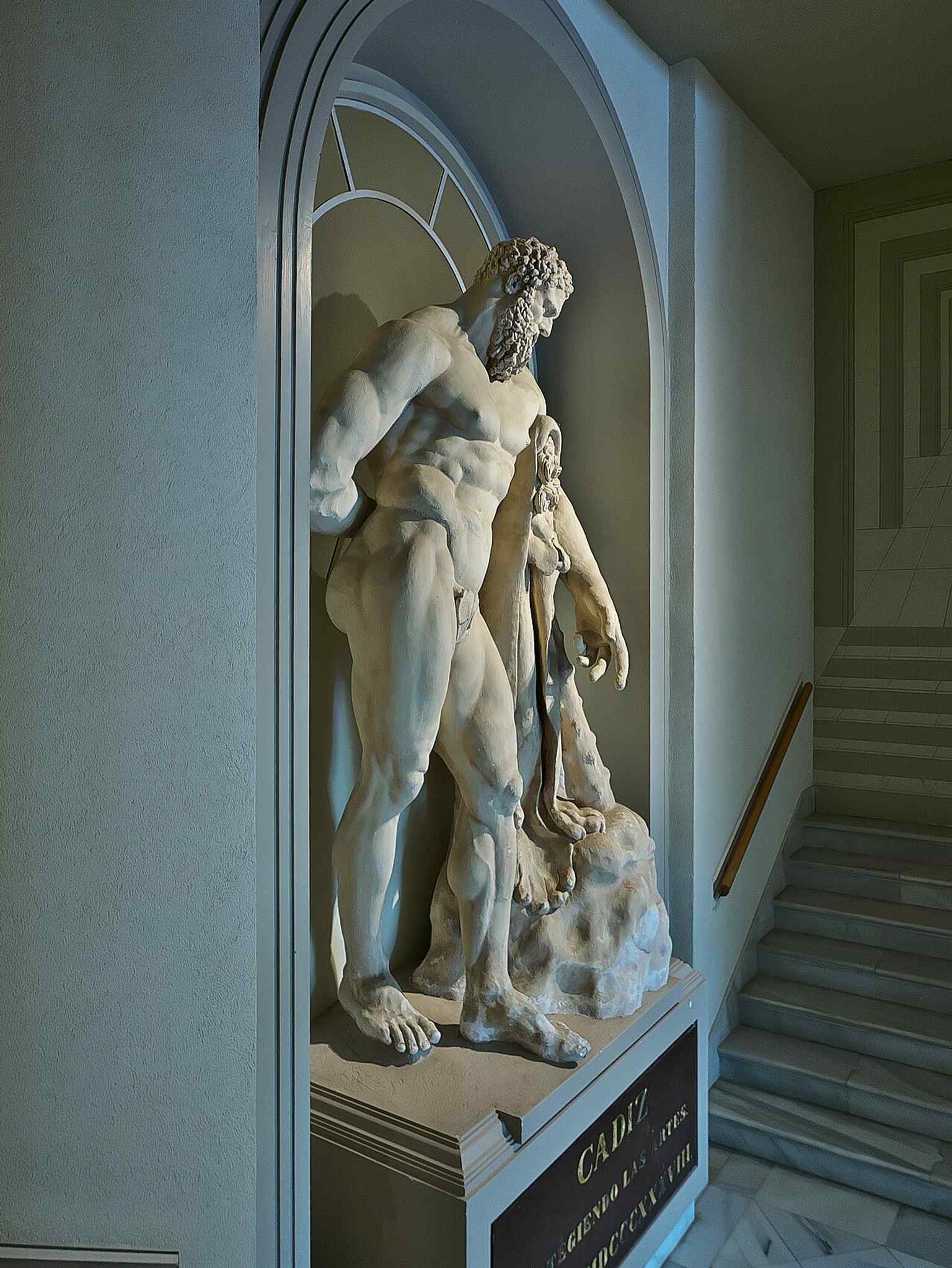 A plaster cast of the Farnese Hercules, echoing the museum’s classical sculpture displays and mythological themes.