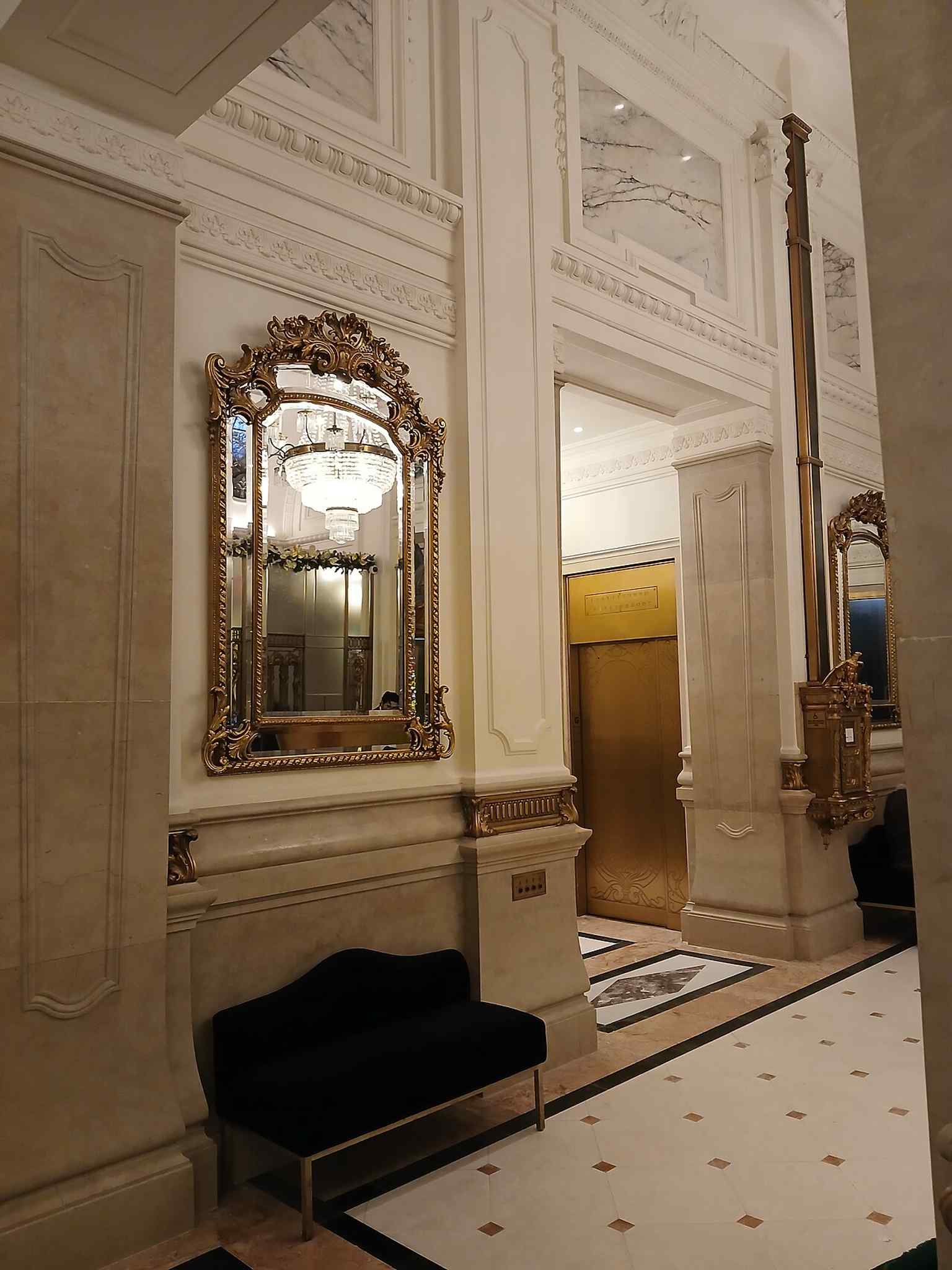 The first-floor hall reflects the marble-lined public rooms that made the St. Regis feel like a grand private club.