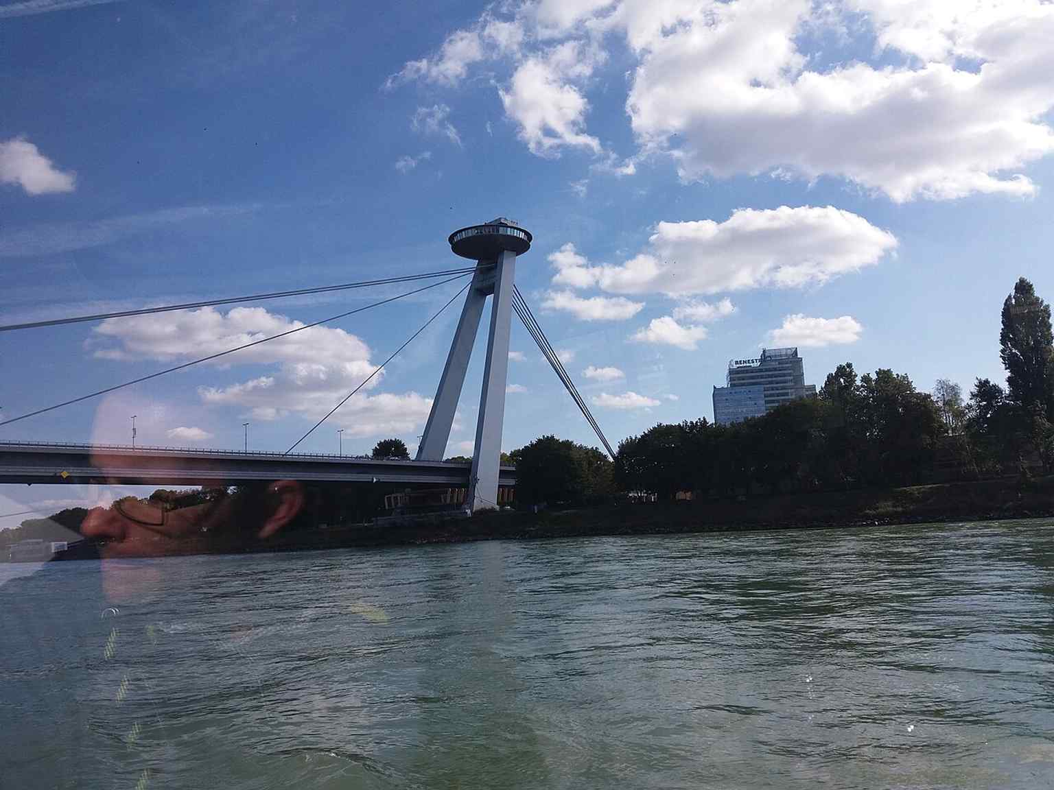 Seen from a boat on the Danube, this angle emphasizes the bridge’s long span and the lack of any river pillar beneath it.