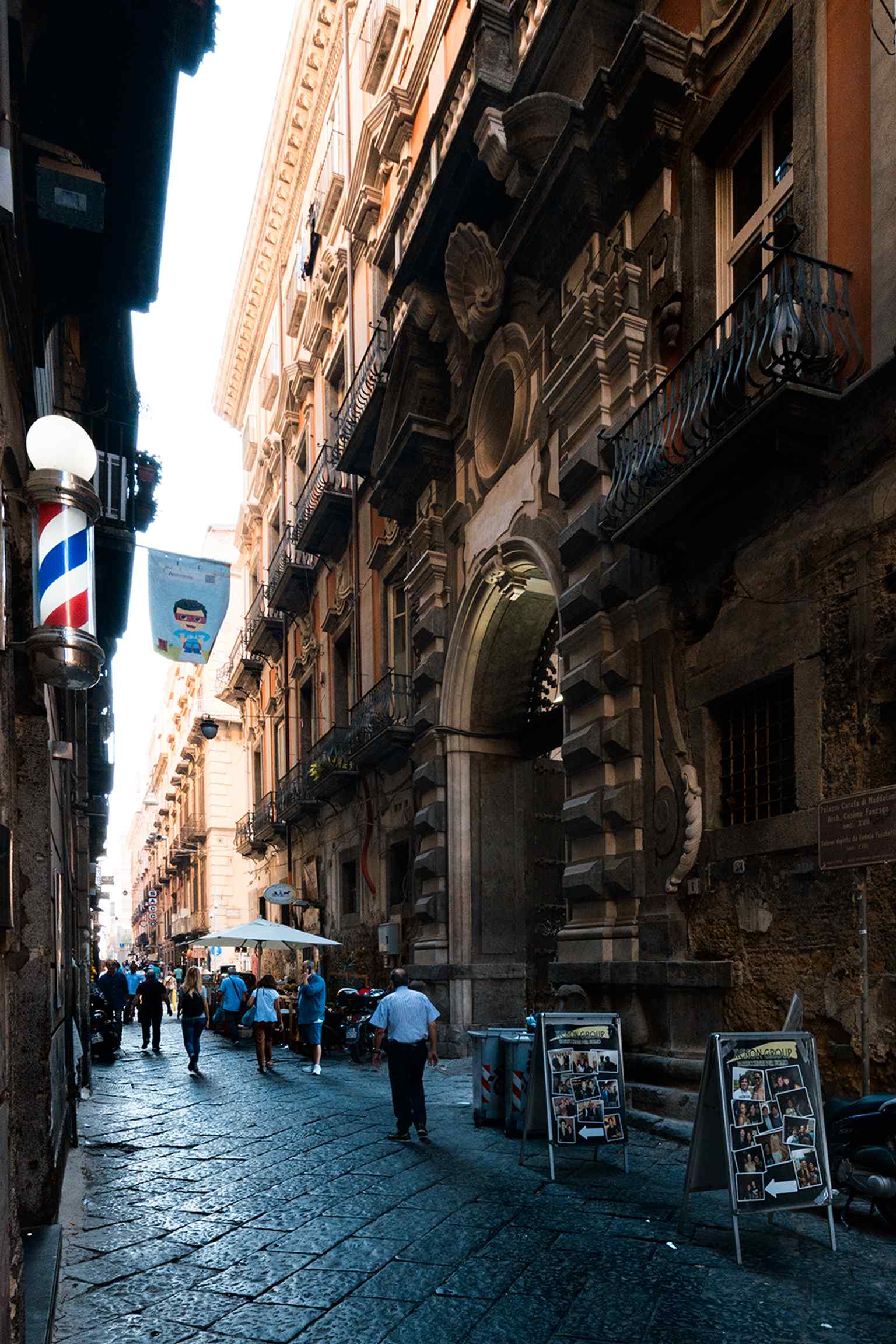 This grand portal, designed by Cosimo Fanzago, was intended as a 'scenographic machine' to announce the Carafa family's return to dominance after the Masaniello revolt, originally crowned with a bust of Diomede V.