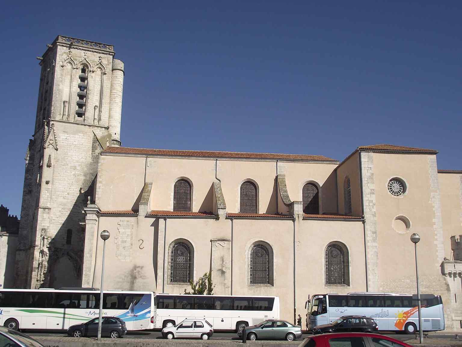 A wide exterior shot that captures the church’s tucked-away setting near the Old Port, as described in the tour text.