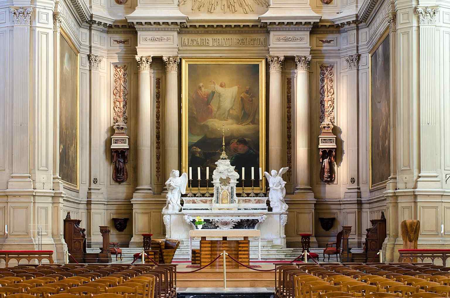 A clear view into the choir, where the 18th-century marble high altar and later paintings anchor the church’s interior history.