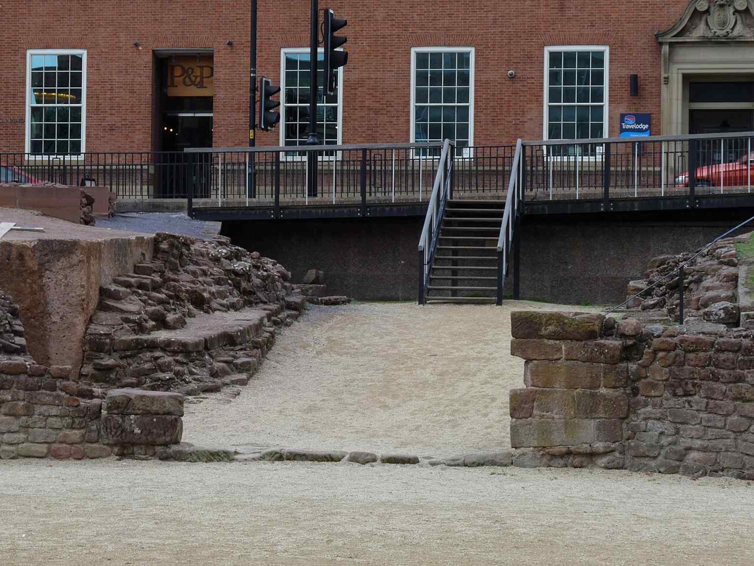 The modern stairway down to the arena floor, a clear detail of how visitors enter the excavated amphitheatre today.