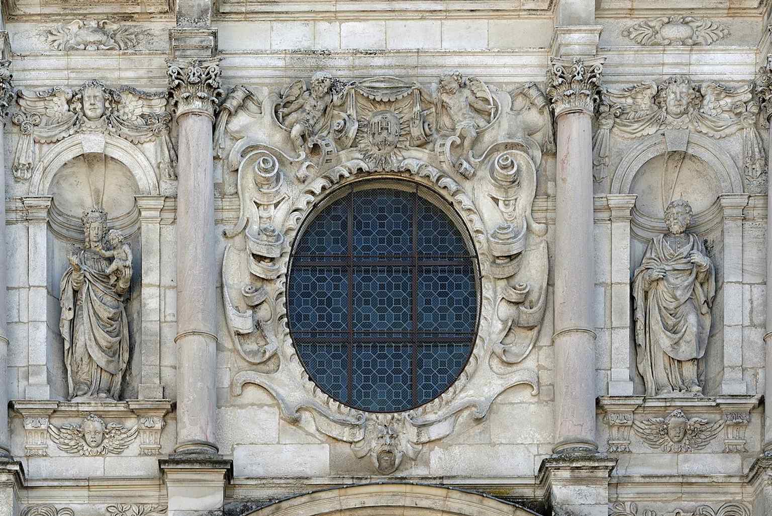A close-up of the Prophet Elijah statue, one of the significant figures sculpted into the chapel's elaborate baroque facade.