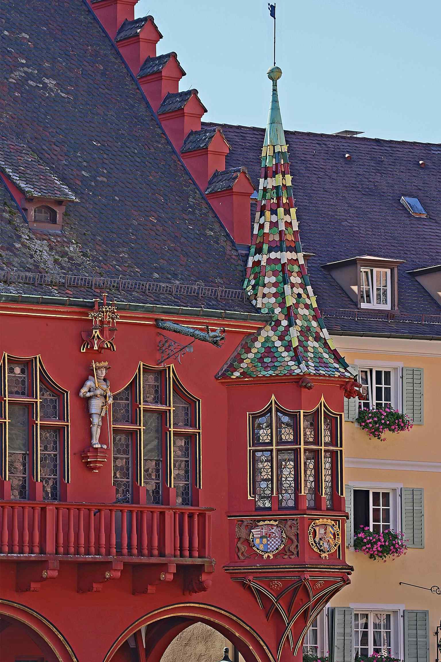 One of the ornate corner oriels, a signature feature of the façade decorated with Habsburg symbolism.