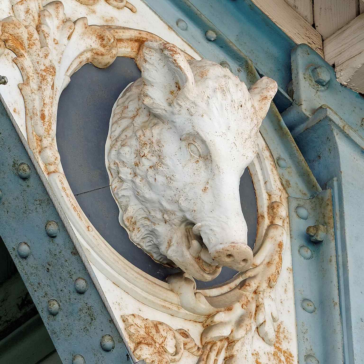 Discover a detail on the arches: a boar's head motif, one of many animal and symbolic carvings, including deer and fish, that celebrate the market's connection to local produce and game.