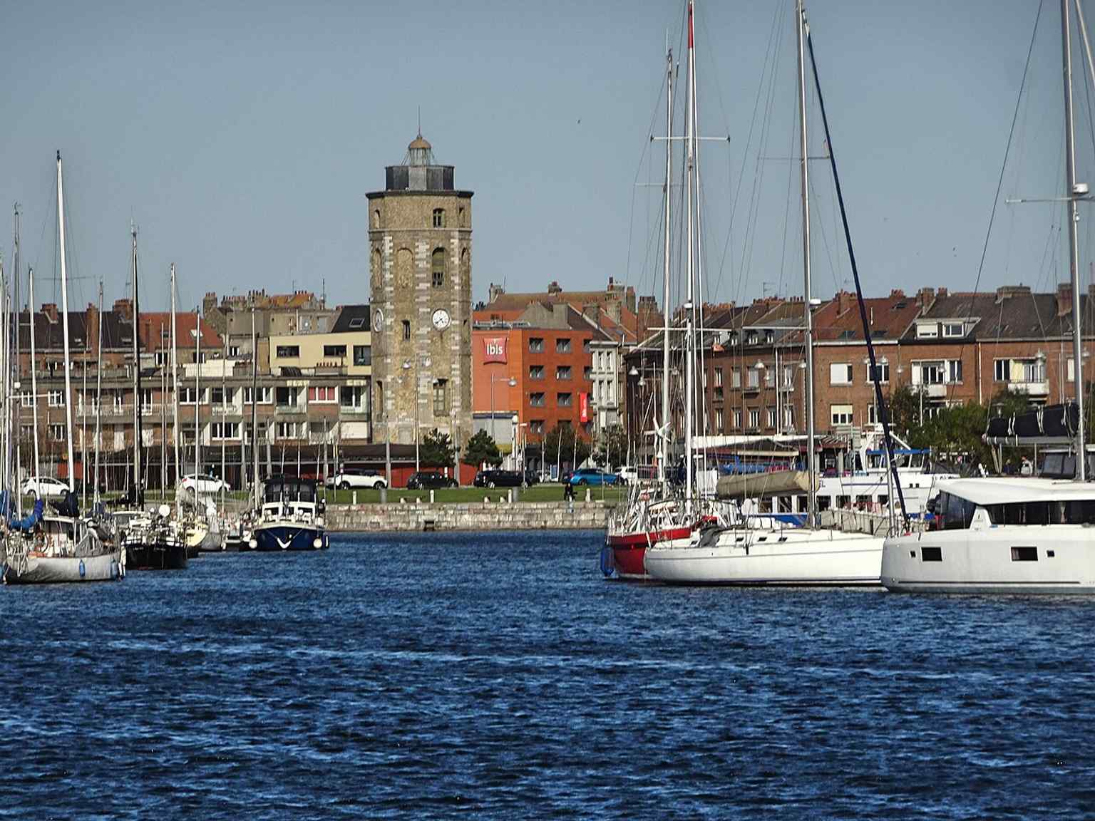 A modern full view of the Leughenaer Tower in Dunkirk, helping show the landmark’s preserved medieval silhouette and historic status.