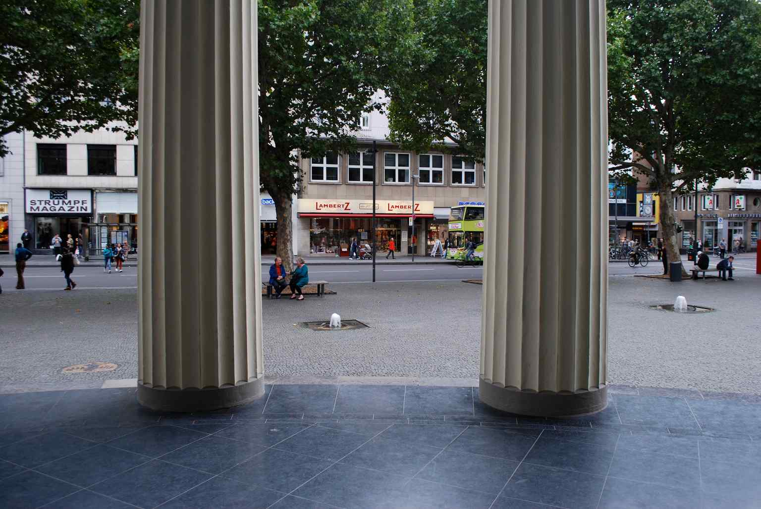 A close-up of the Doric columns and pilasters surrounding the Elisenbrunnen's central rotunda, a hallmark of its Neoclassical architecture.