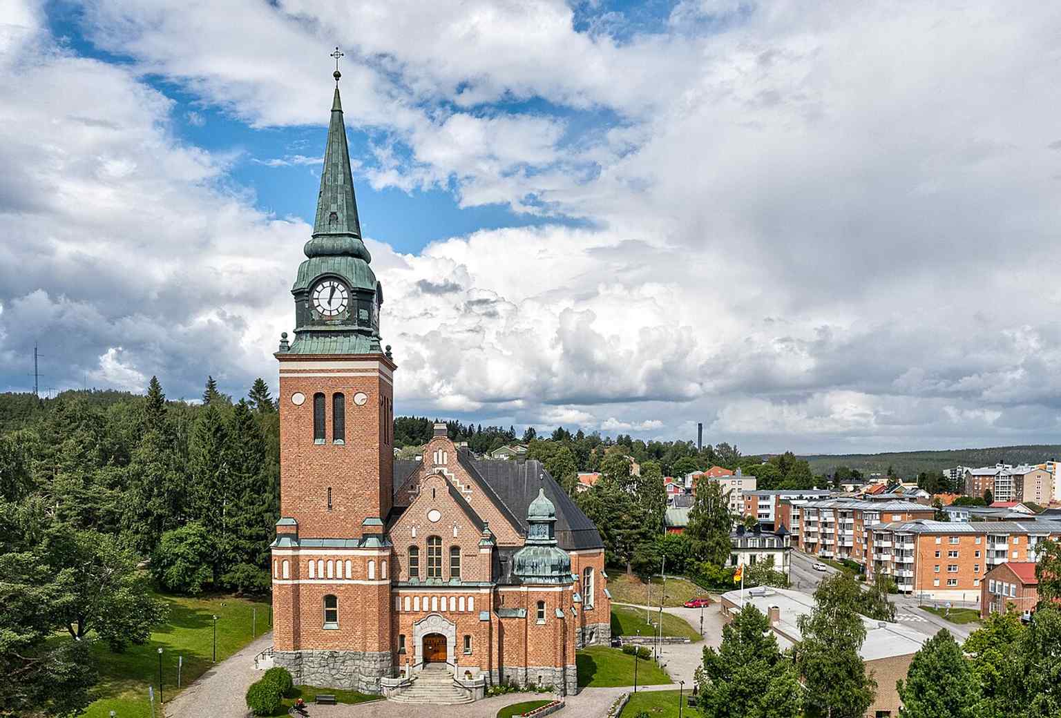 A sweeping aerial view of Örnsköldsviks Church and its setting in the town, useful for showing the landmark’s overall footprint and location.