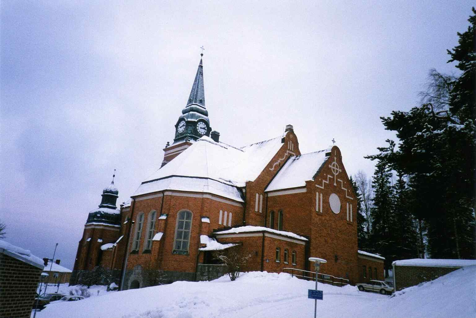 The church seen from the northeast in late autumn — a clear exterior view of the 1910 church designed by Gustaf Améen.
