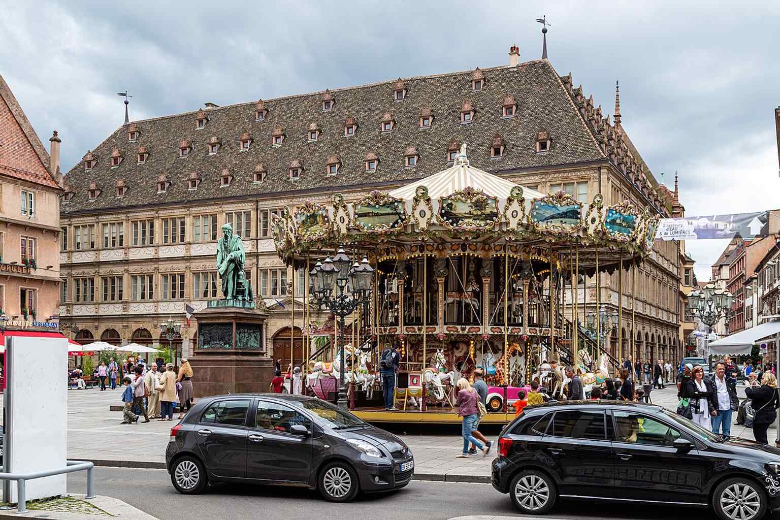 The Gutenberg statue, the carousel, and the former city hall in one frame — the key trio that defines the square today.