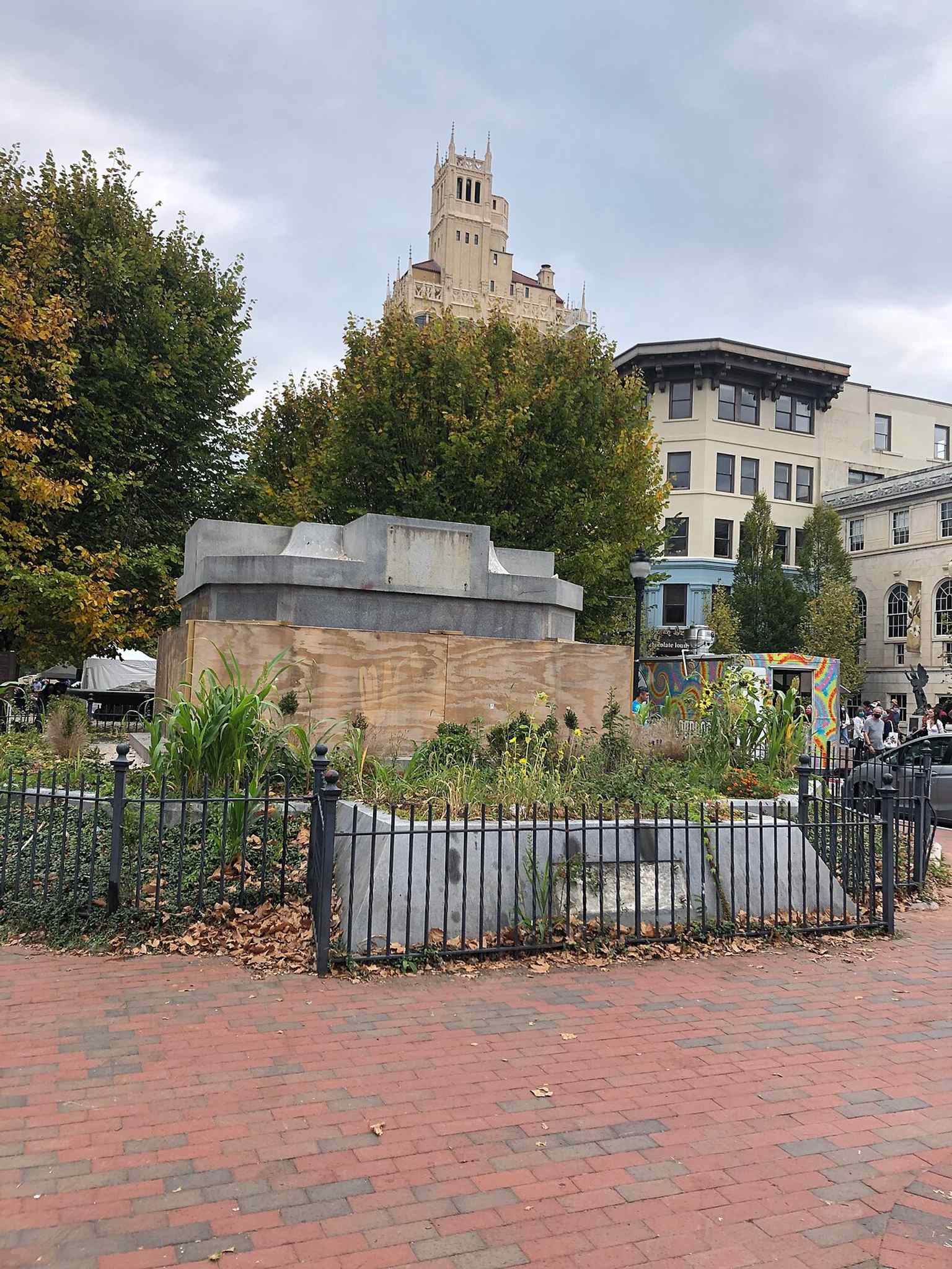 The former site of the monument left to weeds in 2021, a stark reminder that the obelisk was removed in 2021.