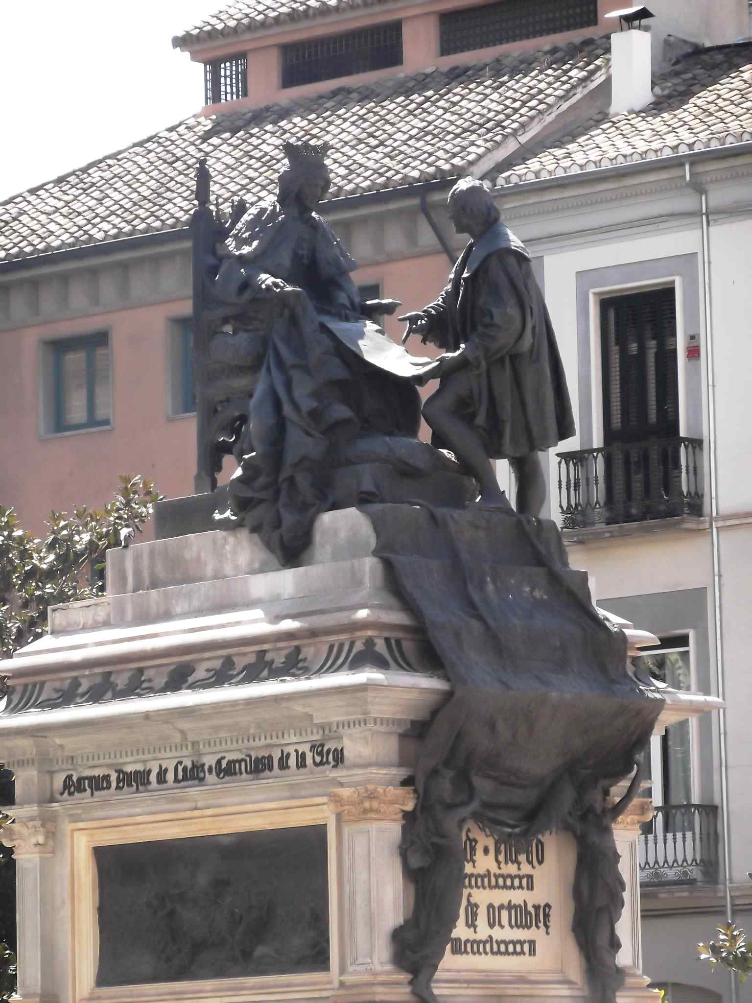This detail shot captures the core sculptural group, emphasizing the moment Columbus persuades Queen Isabella I of Castile, a key scene depicted in the monument.